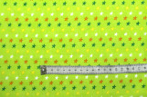 Tissu Popeline Coton Imprimé Fond Vert Anis Étoiles colorées -Au Mètre